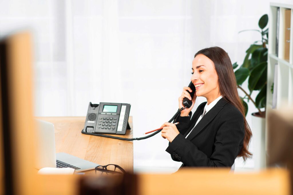A SoundLine customer taking a call at her desk phone